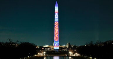 Washington Monument lit up with the projection of 