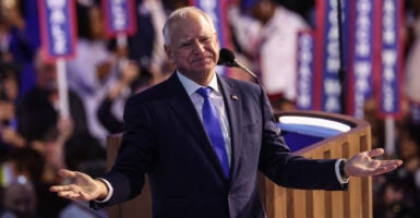 Tim Walz with his arms outstretched at DNC convention.