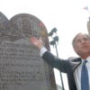 Greg Abbott gestures toward a Ten Commandments monument outside Texas State Capitol building in 2005.