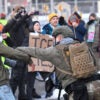 Protestors clash with federal agents outside the Bishop Henry Whipple Federal Building in Saint Paul, Minnesota, on January 8, 2026. A US Immigration and Customs Enforcement (ICE) agent shot and killed an American woman on the streets of Minneapolis January 7, leading to huge protests and outrage from local leaders who rejected White House claims she was a domestic terrorist. The woman, identified in local media as 37-year-old Renee Nicole Good, was hit at point blank range as she apparently tried to drive away from agents who were crowding around her car, which they said was blocking their way. (Photo by Octavio JONES / AFP via Getty Images)