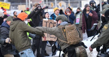 Protestors clash with federal agents outside the Bishop Henry Whipple Federal Building in Saint Paul, Minnesota, on January 8, 2026. A US Immigration and Customs Enforcement (ICE) agent shot and killed an American woman on the streets of Minneapolis January 7, leading to huge protests and outrage from local leaders who rejected White House claims she was a domestic terrorist. The woman, identified in local media as 37-year-old Renee Nicole Good, was hit at point blank range as she apparently tried to drive away from agents who were crowding around her car, which they said was blocking their way. (Photo by Octavio JONES / AFP via Getty Images)