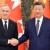 Chinese President Xi Jinping shakes hands with Canadian Prime Minister Mark Carney at the Great Hall of the People in Beijing, capital of China,