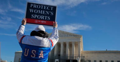 WASHINGTON, DC - JANUARY 13: Protesters against transgender athletes competing in women's sports gather outside the Supreme Court on January 13, 2026 in Washington, DC. Groups from both sides of the debate gathered on Tuesday morning to protest while two cases that prohibit transgender girls from joining girls' and women's sports teams are heard inside the Supreme Court. Heather Diehl/Getty Images