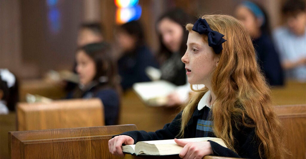 Ten year old schoolgirl at daily church service.
