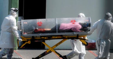 TOPSHOT - Paramedics move a patient suspected of being infected with the novel coronavirus into the 22 Battalion of the Military Police Hospital, in Mexico City, on December 30, 2020. (Photo by PEDRO PARDO / AFP) (Photo by PEDRO PARDO/AFP via Getty Images)