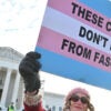 People hold signs outside the US Supreme Court on December 4, 2024 in Washington, DC, during oral argument on whether states can ban certain gender transition medical treatments for young people. The case was brought by three transgender teens, their parents and a doctor who are seeking to ensure health-care access they say is critical. (Photo by ROBERTO SCHMIDT / AFP) (Photo by ROBERTO SCHMIDT/AFP via Getty Images)