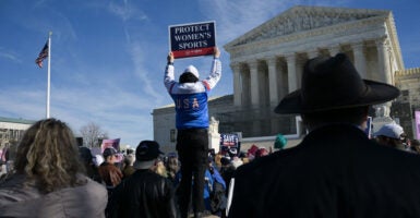 A man holds up a sign reading "Protect women's sports" as he demonstrates outside the US Supreme Court.