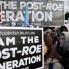 Pro-lifers stand holding their signs, "I AM THE POST-ROE GENERATION."