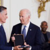 WASHINGTON, DC - JANUARY 4: Sen. Mitt Romney (R-UT) receives the the Presidential Medal of Freedom on behalf of his father, former Michigan Gov. George Romney, from U.S. President Joe Biden in the East Room of the White House on January 4, 2025 in Washington, DC. President Biden awarded 19 recipients with the nation's highest civilian honor. President Biden is awarding 19 recipients with the nation's highest civilian honor. (Photo by Tom Brenner/Getty Images)