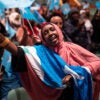 MINNEAPOLIS, MN. - DECEMBER 2022: Sawo Kwao sang and waved the Somali flag Thursday night, December 15, 2022 as a DJ played Somali pop music for the crowd in the auditorium of the Minneapolis Convention Center awaiting the arrival of Somali President Hassan Sheikh Mohamud. Somali President Hassan Sheikh Mohamud is in town to address the members of the Somali community, the largest outside Africa, after attending the U.S. - Africa Leaders Summit in Washington, D.C. this week. (Photo by Jeff Wheeler/Star Tribune via Getty Images)