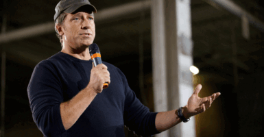 TV personality Mike Rowe , host of "Dirty Jobs", takes part in a roundtable discussion on manufacturing with Republican presidential candidate Mitt RomneySeptember 26, 2012 American Spring Wire in Bedford Heights, Ohio. AFP PHOTO/Mandel NGAN (Photo credit should read MANDEL NGAN/AFP/GettyImages)