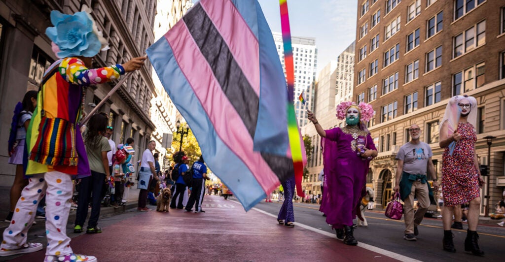 Brude Beaudette, left, waves the Trans Flag as members of the Sisters of Perpetual Indulgence walk down Broadway during the Oakland Pride Parade and Festival in Oakland, Calif., on Sunday, Sept. 7, 2025. (Photo by Carlos Avila Gonzalez/San Francisco Chronicle via Getty Images)