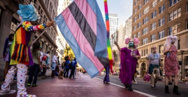Brude Beaudette, left, waves the Trans Flag as members of the Sisters of Perpetual Indulgence walk down Broadway during the Oakland Pride Parade and Festival in Oakland, Calif., on Sunday, Sept. 7, 2025. (Photo by Carlos Avila Gonzalez/San Francisco Chronicle via Getty Images)