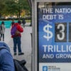 WASHINGTON, DC - OCTOBER 27: A view of a bus shelter at Pennsylvania Avenue and 22nd Street NW where an electronic billboard and a poster display the current U.S. National debt per person and as a nation at 38 Trillion dollars on October 27, 2025 in Washington, DC. (Photo by Jemal Countess/Getty Images for the Peter G. Peterson Foundation)
