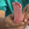 TANGSHAN, CHINA - JANUARY 01: A nurse looks after a newborn baby at a maternal and child health hospital on the first day of 2026 on January 1, 2026 in Tangshan, Hebei Province of China. (Photo by Zhu Dayong/VCG via Getty Images)