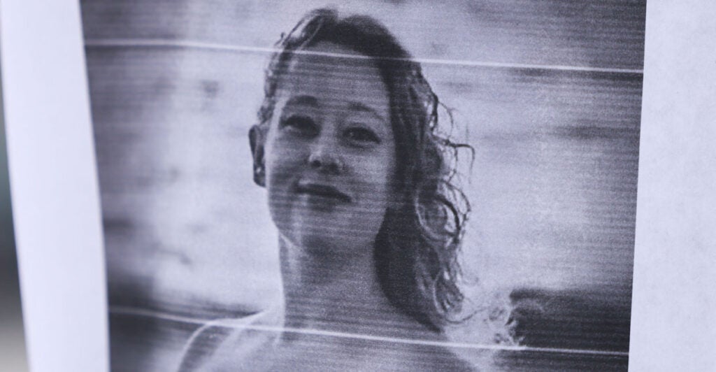 A picture of Renee Nicole Good is displayed near a makeshift memorial for Good, who was shot and killed at point blank range on January 7 by a US Immigration and Customs Enforcement (ICE) agent as she apparently tried to drive away from agents who were crowding around her car, in Minneapolis, Minnesota, on January 8, 2026. A US Immigration and Customs Enforcement (ICE) agent shot and killed an American woman on the streets of Minneapolis January 7, leading to huge protests and outrage from local leaders who rejected White House claims she was a domestic terrorist. (Photo by CHARLY TRIBALLEAU / AFP via Getty Images)