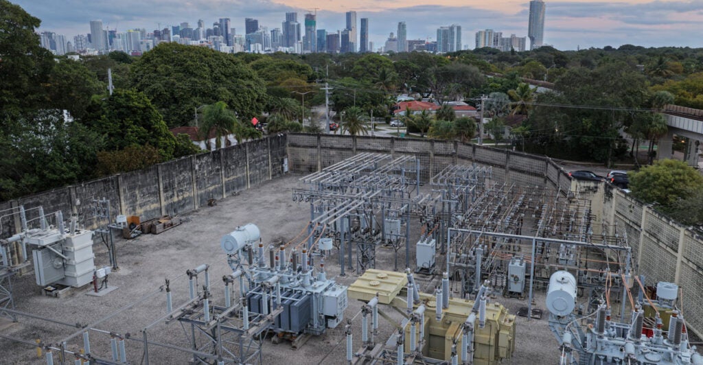 JANUARY 14: In an aerial view, high voltage power lines run through a sub-station along the electrical power grid on January 14, 2026 in Miami, Florida. U.S. President Donald Trump announced that AI tech companies need to ‘pay their own way’ when it comes to their electricity consumption so that Americans don't 'pick up the tab' for their data centers. (Photo by Joe Raedle/Getty Images)