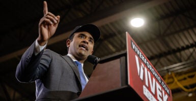 Vivek Ramaswamy stands at a podium and gestures.