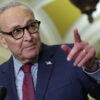 Sen. Chuck Schumer points as he speaks to reporters at a Capitol press conference.