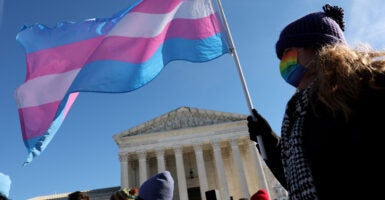 WASHINGTON, DC - DECEMBER 04: A transgender rights supporter takes part in a rally outside of the U.S. Supreme Court as the high court hears arguments in a case on transgender health rights on December 04, 2024 in Washington, DC. The Supreme Court is hearing arguments in US v. Skrmetti, a case about Tennessee's law banning gender-affirming care for minors and if it violates the Constitution’s equal protection guarantee. (Photo by Kevin Dietsch/Getty Images)