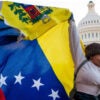 Woman holds Venezuelan flag at the U.S. Capitol.