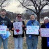 A group of young people holding up signs at the March for Life 2026