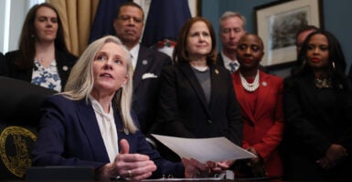 Virginia Governor Abigail Spanberger signs executive orders after being sworn into office at the Virginia State Capitol January 17, 2026 in Richmond, Virginia.