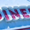 A red "DINER" sign against a white background,
