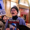 Protesters shout slogans against US Immigration and Customs Enforcement (ICE) outside of the office of Minnesota Governor Tim Walz at the Minnesota State Capitol Building in St. Paul, Minnesota, on January 27, 2026. On January 24, federal agents shot and killed Alex Pretti, a 37-year-old ICU nurse, while scuffling with him on an icy roadway in Minneapolis, less than three weeks after an immigration officer fired on Renee Good, also 37, killing her in her car. The fatal shootings has reignited accusations that federal agents enforcing US President Donald Trump's militarized immigration crackdown are inexperienced, under-trained and operating outside law enforcement norms. (Photo by ROBERTO SCHMIDT / AFP via Getty Images)