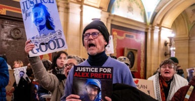 Protesters shout slogans against US Immigration and Customs Enforcement (ICE) outside of the office of Minnesota Governor Tim Walz at the Minnesota State Capitol Building in St. Paul, Minnesota, on January 27, 2026. On January 24, federal agents shot and killed Alex Pretti, a 37-year-old ICU nurse, while scuffling with him on an icy roadway in Minneapolis, less than three weeks after an immigration officer fired on Renee Good, also 37, killing her in her car. The fatal shootings has reignited accusations that federal agents enforcing US President Donald Trump's militarized immigration crackdown are inexperienced, under-trained and operating outside law enforcement norms. (Photo by ROBERTO SCHMIDT / AFP via Getty Images)