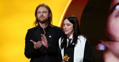 LOS ANGELES, CALIFORNIA - FEBRUARY 01: FINNEAS and Billie Eilish accept the Song of the Year award for 