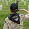 WESTWOOD, CA - MAY 24: Julian Holkenborg of Boy Scout Troop 642 from Woodland Hills salutes after planting a flag at the Los Angeles National Cemetery in Westwood, CA on Saturday, May 24, 2025. He was among the 3,500 boy scouts and girls scouts who planted 90,000 flags ahead of Monday's Memorial Day ceremony. They were instructed to plant one flag per headstone, say the name on the headstone and salute. (Myung J. Chun / Los Angeles Times via Getty Images).