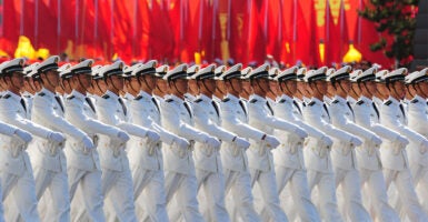 Chinese People's Liberation Army (PLA) naval officers march pass Tiananmen Square during the National Day parade in Beijing on October 1, 2009. China formally kicked off mass celebrations of 60 years of communist rule with a 60-gun salute that rung out across Beijing's historic Tiananmen Square. AFP PHOTO/FREDERIC J. BROWN (Photo credit should read FREDERIC J. BROWN/AFP via Getty Images)