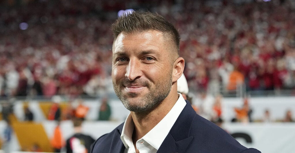 MIAMI GARDENS, FL - JANUARY 19: Former NFL player Tim Tebow smiles on the sidelines before the Indiana Hoosiers versus the Miami Hurricanes College Football Playoff National Championship Game Presented by AT&T on January 19, 2026, at Hard Rock Stadium in Miami Gardens, FL. (Photo by Peter Joneleit/Icon Sportswire via Getty Images)