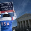 TOPSHOT - A man holds up a sign reading "Protect women's sports" as he demonstrates outside the US Supreme Court as justices hear arguments in challenges to state bans on transgender athletes in women's sports on January 13, 2026, in Washington, DC. The US Supreme Court on January 13 wades into the hot-button issue of transgender athletes in girls' and women's sports. The conservative-dominated court is to hear challenges to state laws in Idaho and West Virginia banning transgender athletes from female competition. More than two dozen US states have passed laws in recent years barring athletes who were assigned as male at birth from taking part in girls' or women's sports. (Photo by Oliver Contreras / AFP via Getty Images)