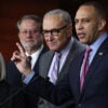 Hakeem Jeffries points while addressing reporters alongside Sen. Chuck Schumer, Sen. Gary Peters, and Sen. Patty Murray.