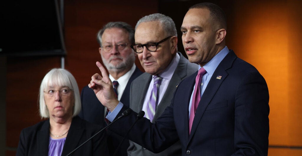 Hakeem Jeffries points while addressing reporters alongside Sen. Chuck Schumer, Sen. Gary Peters, and Sen. Patty Murray.
