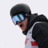 American skier Hunter Hess in helmet in goggles against a white background with his mouth open wide.