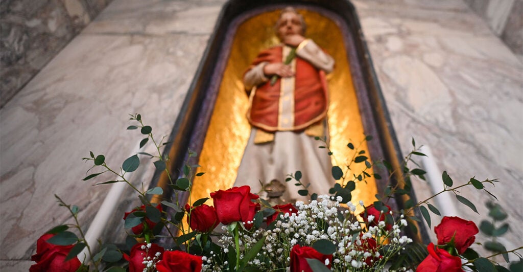 DUBLIN, IRELAND - FEBRUARY 13: Roses in front of St. Valentine's relics and statue, are seen on the eve of Saint Valentine's Day at the Carmelite Church, in Dublin, Ireland on February 13, 2023. Bishop Denis Nulty traditionally performs a ritual for engaged couples, Ilona Catharine Dorrepaal and Patrick Michael Lennon, and Orla Gavin and Patrick Corcoran, in front of the statue of Saint Valentine. (Photo by Artur Widak/Anadolu Agency via Getty Images)