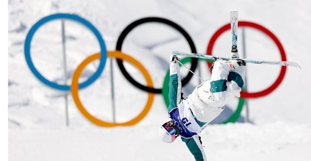 LIVIGNO, ITALY - FEBRUARY 12: Cooper Woods of Team Australia warms up in front of the Olympic Rings prior to the Men's Freestyle Skiing Moguls Final 1 on day six of the Milano Cortina 2026 Winter Olympic games at Livigno Air Park on February 12, 2026 in Livigno, Italy. (Photo by Michael Reaves/Getty Images)