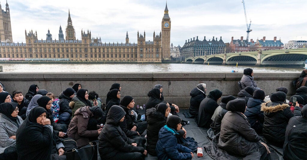 LONDON, UNITED KINGDOM - 2026/01/18: Worshippers seen sitting during the religious event. Shia Muslims gathered at Westminster Bridge to commemorate the martyrdom of Imam Musa al-Kazim taking part in a religious procession marked by ritual chest beating known as Azadari and Matam. The annual observance honours the seventh Shia Imam and serves as a public expression of mourning, sacrifice, and devotion within the Shia Islamic tradition. (Photo by Andrea Domeniconi/SOPA Images/LightRocket via Getty Images)