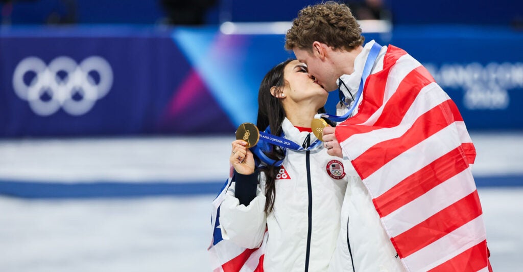 Gold medalists Madison Chock and Evan Bates of Team United States share a kiss after the medal ceremony for the Team Event on day two of the Milano Cortina 2026 Winter Olympic games at Milano Ice Skating Arena on February 8, 2026 in Milan, Italy.