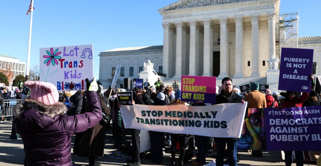Opponents of gender affirming care for minors protest in front of Supreme Court.