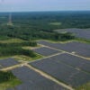 In an aerial view, the Amazon Fort Powhatan Solar Farm is seen on August 19, 2022 in Disputanta, Virginia. Amazon has partnered with Dominion Energy to build over 19 solar farms in the state, which are used to power Amazon Web Services, its cloud-computing service, and eventually its HQ2 location in Northern Virginia once complete. Amazon is the world's largest corporate buyer of renewable energy, with a company pledge to use 100% renewable energy for all of its operations by 2030. (Photo by Drew Angerer/Getty Images)