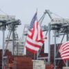 Long Beach, CA - July 11: American flags line the area of the existing wharf that is planned to be filled in with dirt as the Port of Long Beach officials announce a major South Slip Fill Project at the International Transportation Service, LLC (ITS) terminal, a $365 million terminal expansion that will support some of the world's largest container ships at the Port of Long Beach. Details of the multi-million-dollar expansion and its impact on international trade, local employment, and the regional economy were revealed. Photo taken at the Port of Long Beach in Long Beach Friday, July 11, 2025. Port and other officials will describe the significance of this project to Southern California, shippers, and the U.S. The announcement will be made in the middle of one of the country's busiest, largest port operations, with tall ship-to-shore cranes and stacks of containers in the background. (Allen J. Schaben / Los Angeles Times via Getty Images)