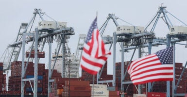 Long Beach, CA - July 11: American flags line the area of the existing wharf that is planned to be filled in with dirt as the Port of Long Beach officials announce a major South Slip Fill Project at the International Transportation Service, LLC (ITS) terminal, a $365 million terminal expansion that will support some of the world's largest container ships at the Port of Long Beach. Details of the multi-million-dollar expansion and its impact on international trade, local employment, and the regional economy were revealed. Photo taken at the Port of Long Beach in Long Beach Friday, July 11, 2025. Port and other officials will describe the significance of this project to Southern California, shippers, and the U.S. The announcement will be made in the middle of one of the country's busiest, largest port operations, with tall ship-to-shore cranes and stacks of containers in the background. (Allen J. Schaben / Los Angeles Times via Getty Images)