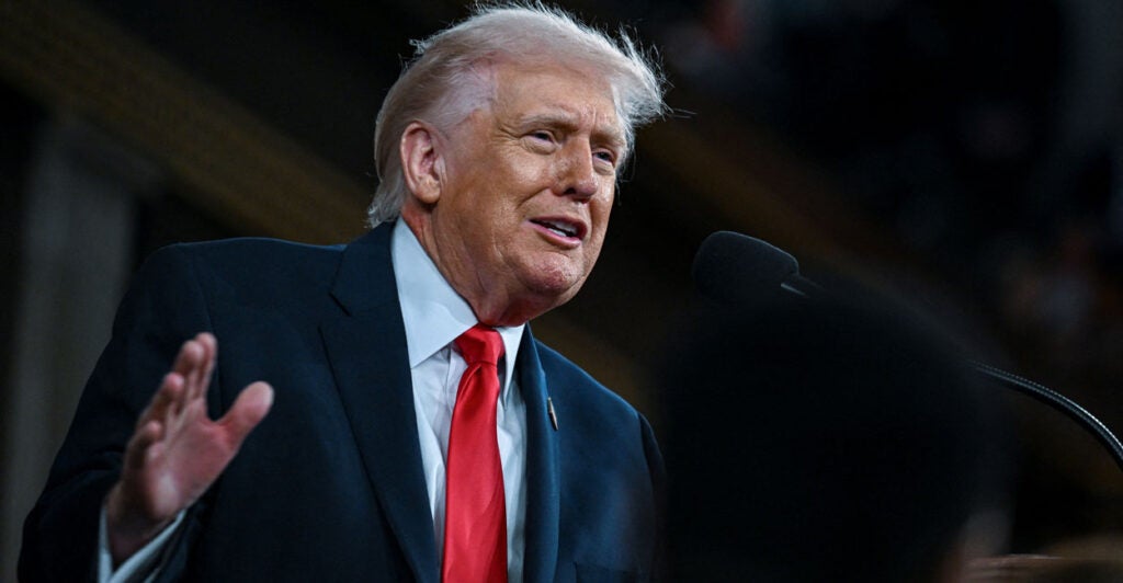 Low angle shot of President Trump, his right hand raised delivering the State of the Union.