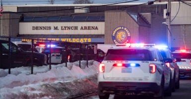 Police stand outside the perimeter they created around the Dennis M. Lynch Arena where a shooting occurred earlier today in Pawtucket, Rhode Island, on February 16, 2026. At least two people were killed and three wounded in a shooting at an ice rink in the northeastern US town of Pawtucket on Monday, authorities said, with social media footage showing frightened teenagers fleeing the sound of gunshots. 
