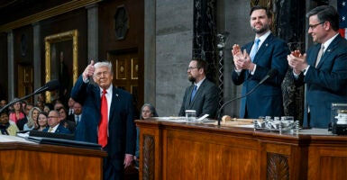 WASHINGTON, DC - FEBRUARY 24: U.S. President Donald Trump arrives to deliver the State of the Union address during a joint session of Congress in the House Chamber at the Capitol on February 24, 2026 in Washington, DC. Seated behind him are Vice President JD Vance and House Speaker Mike Johnson (R-LA). Trump delivered his address days after the Supreme Court struck down the administration's tariff strategy, and amid a U.S. military buildup in the Persian Gulf threatening Iran. (Photo by Kenny Holston-Pool/Getty Images)