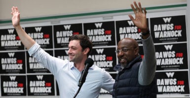 ATHENS, GEORGIA - DECEMBER 04: Georgia Democratic Senate candidate U.S. Sen. Raphael Warnock (D-GA) (R) and Sen. Jon Ossoff (D-GA) wave to students before speaking at a Dawgs for Warnock rally at the University of Georgia December 4, 2022 in Athens, Georgia. Sen. Warnock continues to campaign throughout Georgia for the runoff election on December 6 against his Republican challenger Herschel Walker. (Photo by Win McNamee/Getty Images)